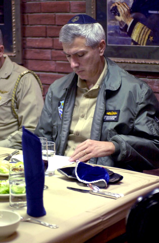 US Navy 030417-N-8273J-004 Rear Adm. Samuel Jones Locklear, Commander Cruiser Destroyer Group Five (CCDG-5), reads from the Passover Hagaddah (prayer book) during a Passover Seder dinner in the wardroom aboard USS Nimitz (CVN 6