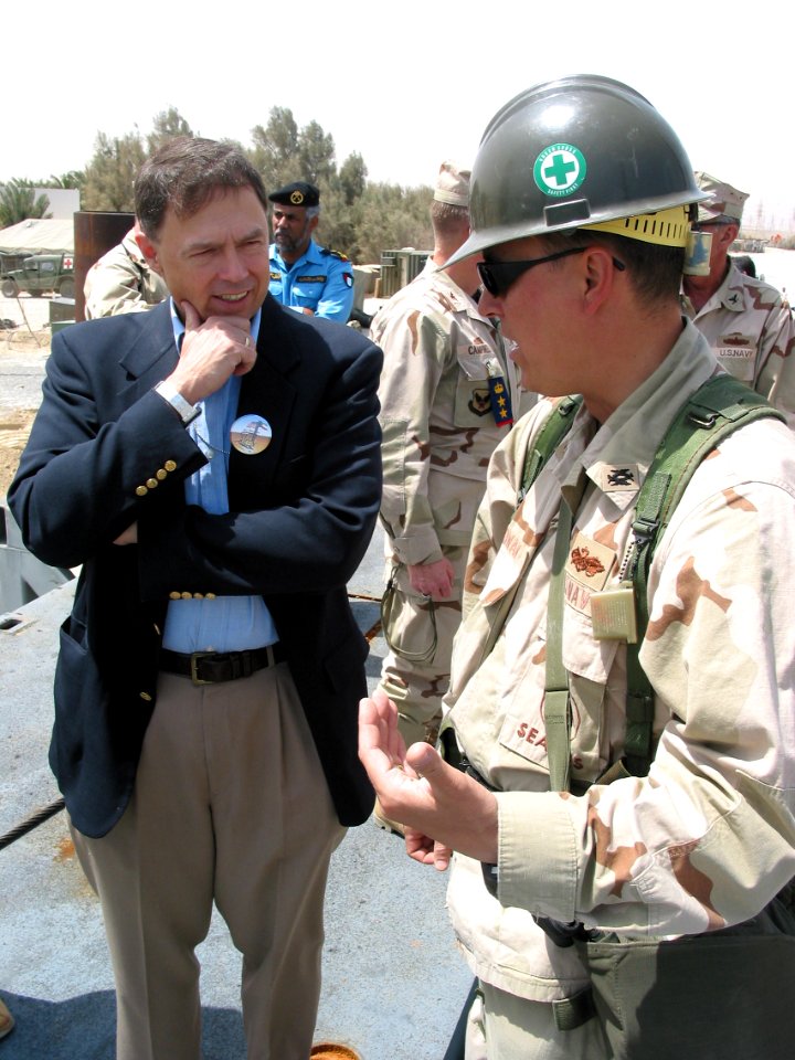 US Navy 030403-N-1050K-021 From left, the Honorable Richard H. Jones, U.S. Ambassador to the State of Kuwait, listens while Lt. Cmdr. Timothy Cowan, Operations Officer for Amphibious Construction Battalion Two (ACB-2)