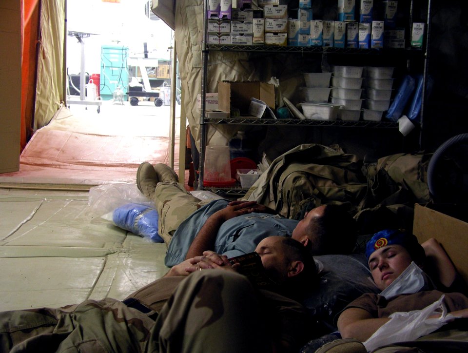 US Navy 030408-N-0728B-001 Fleet Hospital Three (FH-3) Staff members grab a quick break just outside the Operating Room