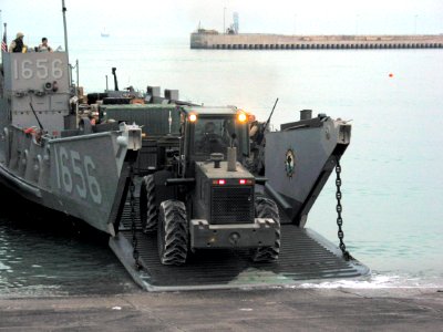 US Navy 030330-N-1050K-005 U.S. Army personnel assigned to the 567th Transportation Company offload water and general military supplies from a U.S. Navy landing craft utility (LCU)