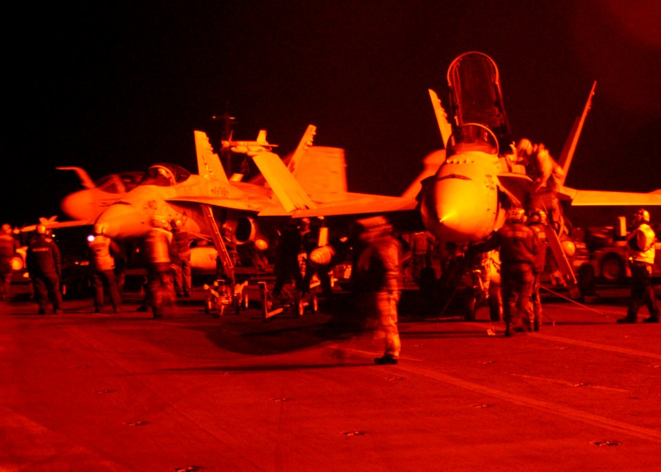 US Navy 030322-N-2410G-509 Carrier Air Wing Eight (CVW-8) aircraft await weapons and make final preparations prior to commencing nightly flight operations on the flight deck aboard the aircraft carrier USS Theodore Roosevelt (C