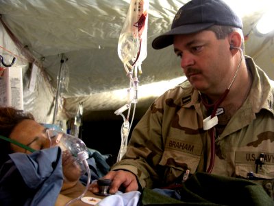 US Navy 030411-N-0728B-002 Lt. Dallas Braham from New Orleans, La., monitors an Iraqi woman at Fleet Hospital Three's (FH-3)
