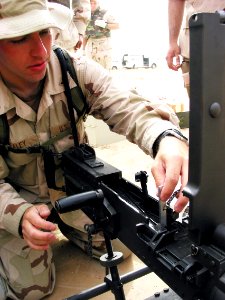 US Navy 030412-N-1050K-014 Gunner's Mate 3rd Class Jeff Healey, 23, from Albuquerque, N.M., tests the barrel alignment of the M2 .50 caliber machine gun