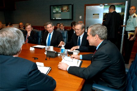 US Navy 030325-D-9880W-046 The Honorable Donald H. Rumsfeld, Secretary of Defense (2nd from right), introduces President George W. Bush (right) to participants at a briefing held in the Pentagon