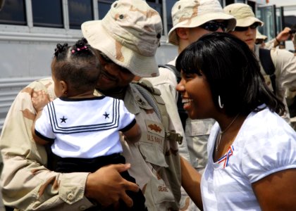 US Navy 080804-N-3857R-006 A Seabee assigned to Naval Mobile Construction Battalion (NMCB) 74 greets his family photo
