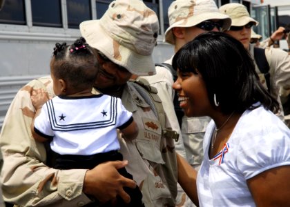 US Navy 080804-N-3857R-006 A Seabee assigned to Naval Mobile Construction Battalion (NMCB) 74 greets his family