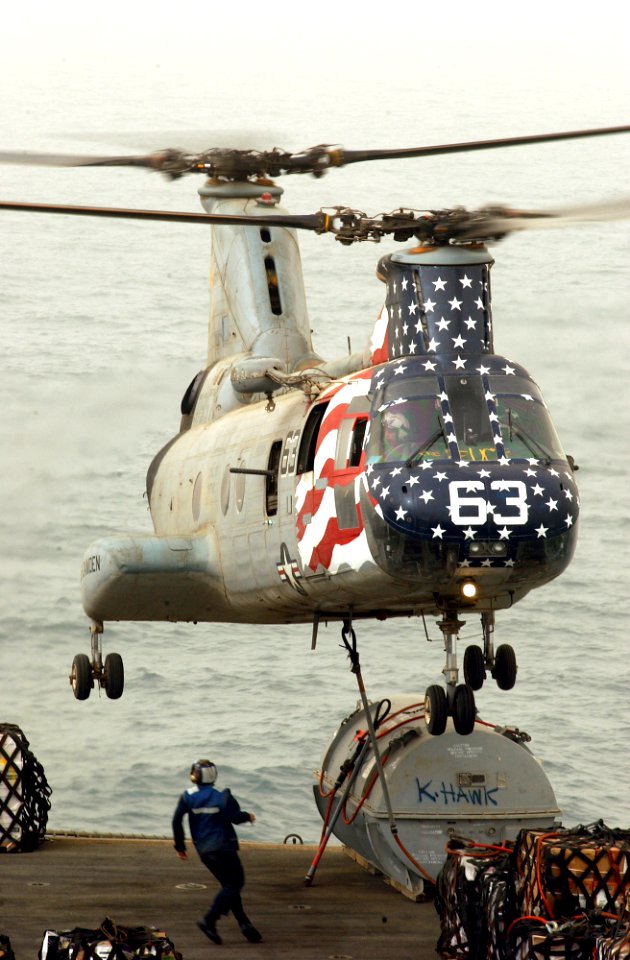 US Navy 030327-N-1810F-003 A CH-46 Sea Knight performs a vertical replenishment between the fast combat support ship USS Camden (AOE 2) and the aircraft carrier USS Kitty Hawk (CV 63)