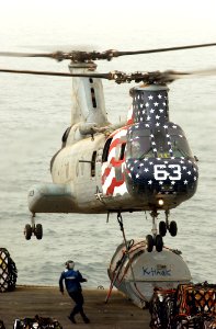 US Navy 030327-N-1810F-003 A CH-46 Sea Knight performs a vertical replenishment between the fast combat support ship USS Camden (AOE 2) and the aircraft carrier USS Kitty Hawk (CV 63)