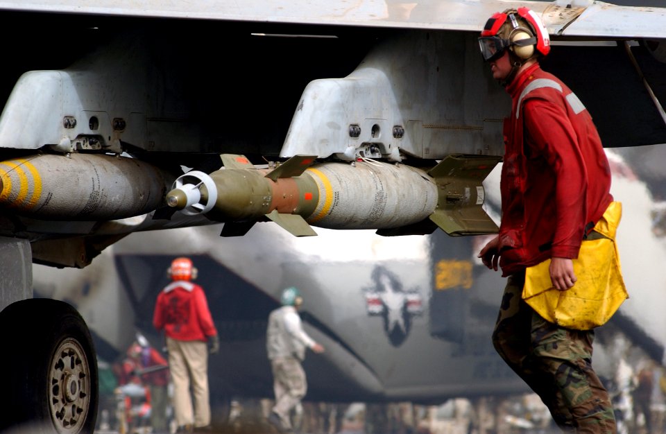 US Navy 030327-N-1810F-020 An aviation ordnanceman pulls the safety pin from a GBU-12 500 Lbs laser guided bomb on an F-A-18 Hornet