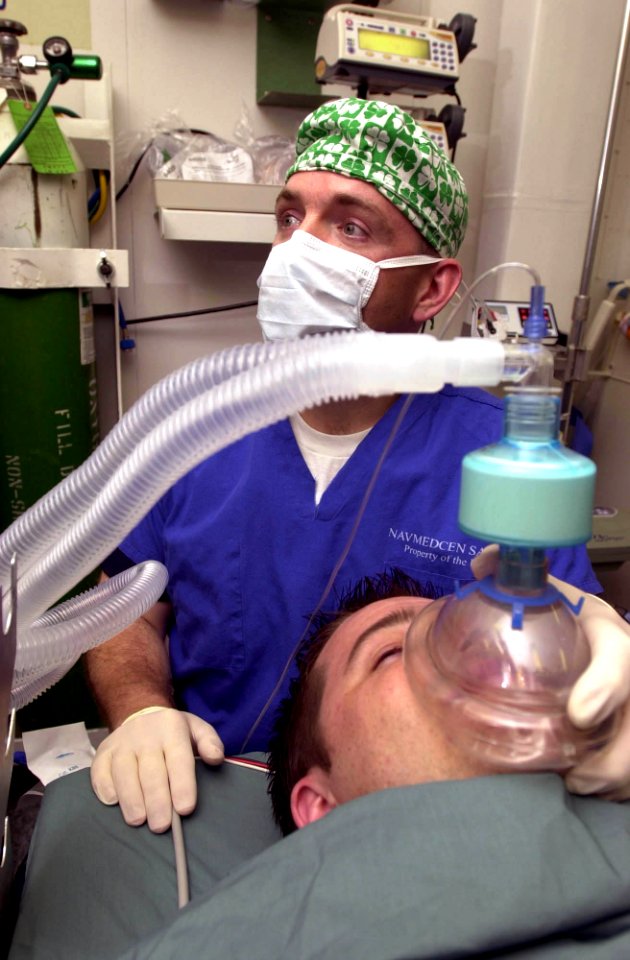 US Navy 030513-N-1577S-001 Lt. Cmdr. Joe Casey, Ship's Anesthetist, trains on anesthetic procedures with Hospital Corpsman 3rd Class Eric Wichman aboard USS Nimitz (CVN 68)