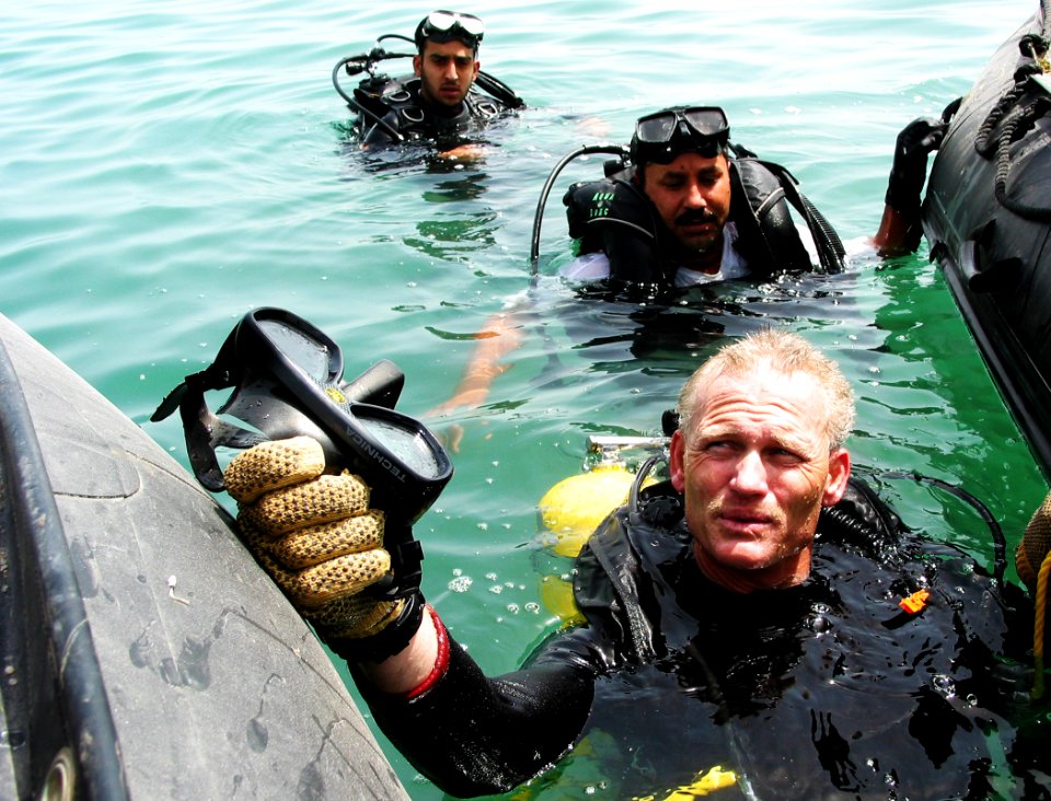 US Navy 030415-N-1050K-012 Master Diver, Master Chief Construction Utilitiesman David Daniels surfaces from a dive with his Kuwaiti counterparts during a recent joint debris clearing operation