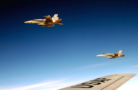 US Navy 030417-F-6809H-019 F-A-18 Hornets are ready to return to their mission after conducting refueling operations with a U.S. Air Force KC-135R Stratotanker