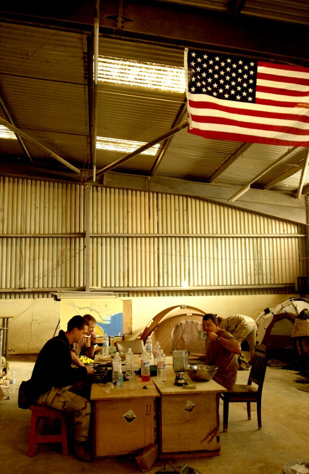 US Navy 030328-N-3783H-345 Members of Commander Task Unit (CTU-55.4.3) eat breakfast in the warehouse they've occupied at the port of Umm Qasr, Iraq