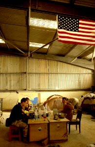 US Navy 030328-N-3783H-345 Members of Commander Task Unit (CTU-55.4.3) eat breakfast in the warehouse they've occupied at the port of Umm Qasr, Iraq photo