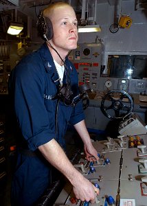 US Navy 030515-N-1512S-041 Electrician's Mate 3rd Class Mike Colberg checks switches while on watch in the Aft Main Machinery Room aboard USS Kearsarge (LHD 3)