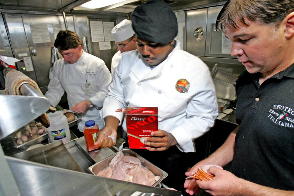 US Navy 081022-N-7441H-002 Chef Dan Dumont, Culinary Specialist Nate Baker, and Chef Chris Soulder prepare lunch