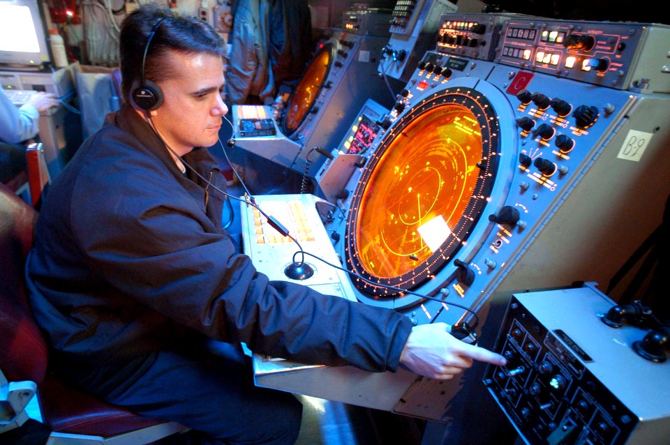 US Navy 030513-N-1512S-014 Air Traffic Controller 1st Class Robert Bacon stands watch in the helo-direction center (HDC)