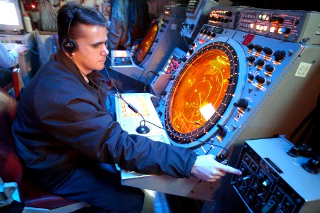 US Navy 030513-N-1512S-014 Air Traffic Controller 1st Class Robert Bacon stands watch in the helo-direction center (HDC)