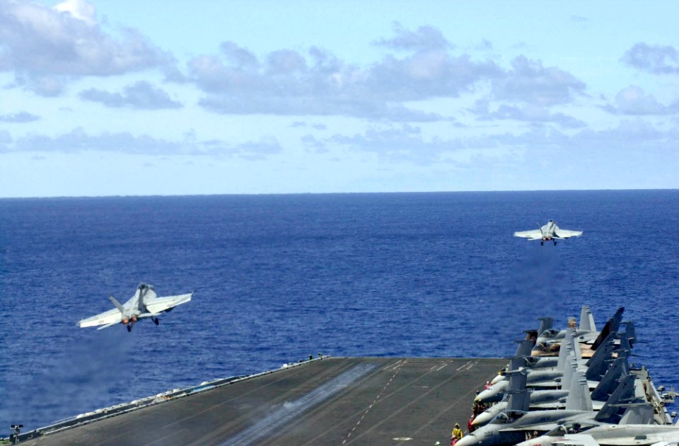US Navy 030330-N-2143T-002 Two F-A-18E Super Hornets assigned to the Tophatters of Strike Fighter Squadron Fourteen (VFA-14) launch from the flight deck of USS Nimitz (CVN 68)