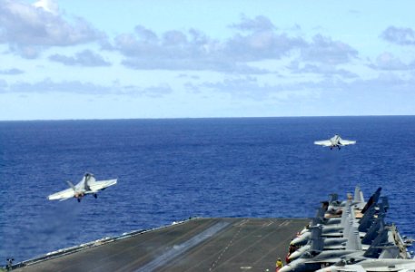 US Navy 030330-N-2143T-002 Two F-A-18E Super Hornets assigned to the Tophatters of Strike Fighter Squadron Fourteen (VFA-14) launch from the flight deck of USS Nimitz (CVN 68)