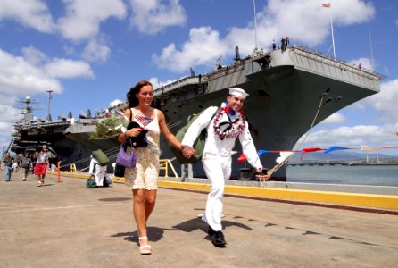 US Navy 030426-N-3228G-022 Electronics Technician 2nd Class Richard Barber and wife go out for liberty after his ship the aircraft carrier USS Abraham Lincoln (CVN 72) pulled into Pearl Harbor for a brief port visit photo