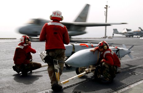 US Navy 030331-N-1810F-002 Aviation ordnancemen watch over Joint Stand-Off Weapons (JSOWs) as an S-3B Viking launches from one of four steam powered catapults aboard USS Kitty Hawk (CV 63)