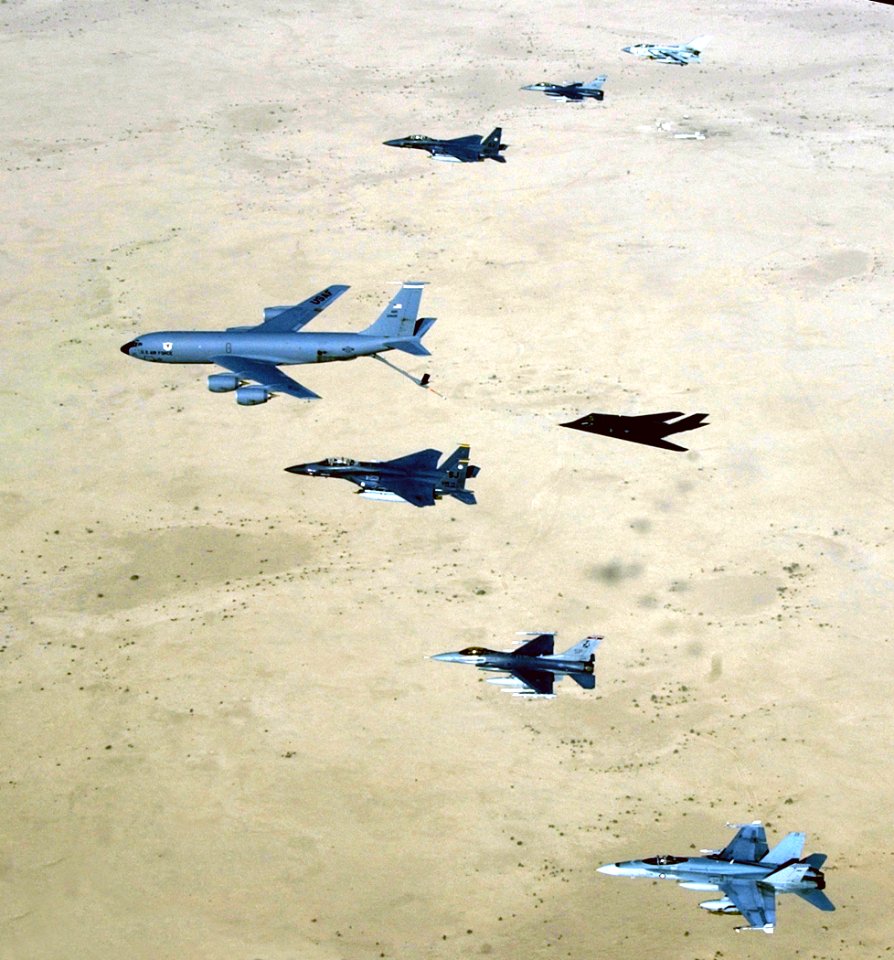 US Navy 030414-F-6591P-002 Aircraft of the 379th Air Expeditionary Wing and coalition counterparts stationed together in a deployed location in southwest Asia fly over the desert