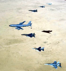 US Navy 030414-F-6591P-002 Aircraft of the 379th Air Expeditionary Wing and coalition counterparts stationed together in a deployed location in southwest Asia fly over the desert
