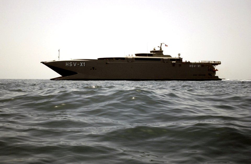 US Navy 030414-N-6141B-049 Joint Venture (HSX-V1) prepares to receive a small boat from the guided missile destroyer USS Mitscher (DDG 57) during underway operations