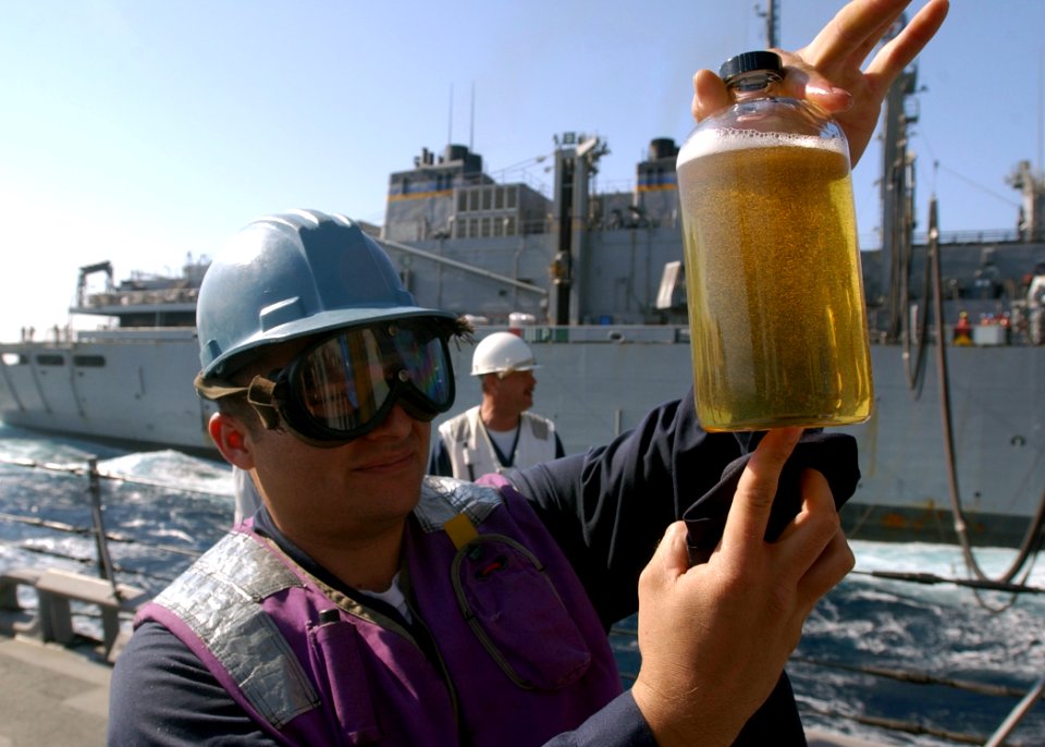 US Navy 030428-N-6141B-004 Engineering Department personnel assigned to the guided missile destroyer USS Donald Cook (DDG 75) check fuel samples received during a refueling at sea (RAS) and connected replenishment (CONREP)