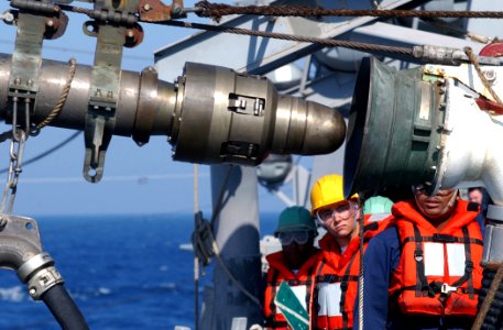 US Navy 030428-N-6141B-003 Deck Department personnel assigned to the guided missile destroyer USS Donald Cook (DDG 75) receive fuel via a connected replenishment