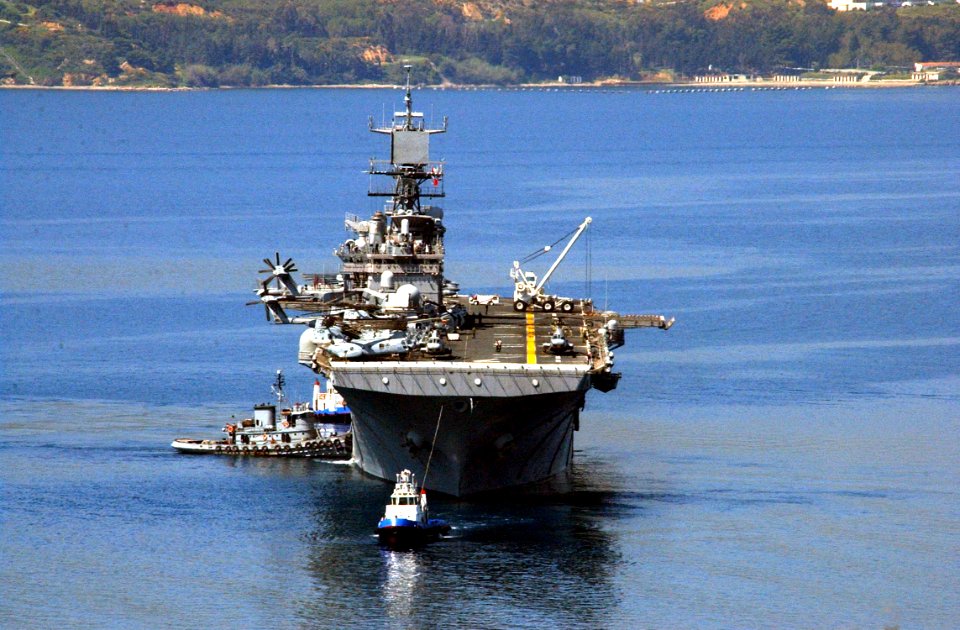 US Navy 030430-N-0780F-021 USS Iwo Jima (LHD 7) is assisted by tugs as she arrives for a port visit at the port of Souda Bay