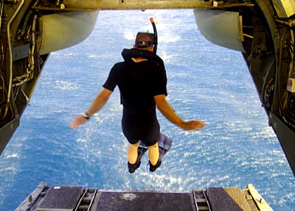 US Navy 030425-N-2819P-070 Aviation Structural Mechanic 3rd Class James R. Stauffer assigned to Helicopter Combat Support Squadron Eight (HC-8) jumps off the back end of a CH-46