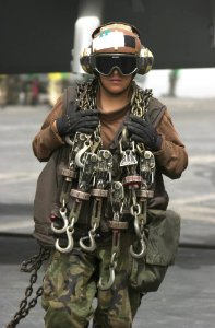 US Navy 030417-N-2385R-011 Airman Ana Tavira from Bloomington, Calif., crosses the flight deck after taking the tie down chains off of an aircraft on the flight deck aboard USS Nimitz (CVN 68) photo