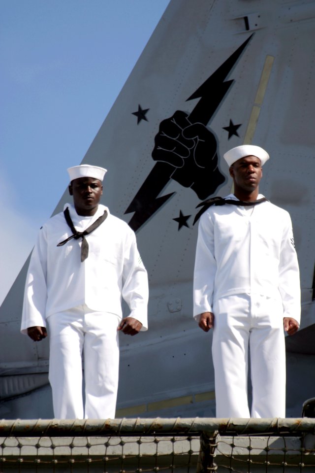 US Navy 030426-N-3228G-018 Sailors man the rails aboard the aircraft carrier USS Abraham Lincoln (CVN 72) while transiting into Pearl Harbor for a brief one-day liberty port after the ship's 10-month deployment in suppor