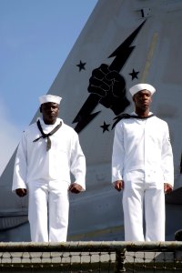 US Navy 030426-N-3228G-018 Sailors man the rails aboard the aircraft carrier USS Abraham Lincoln (CVN 72) while transiting into Pearl Harbor for a brief one-day liberty port after the ship's 10-month deployment in suppor
