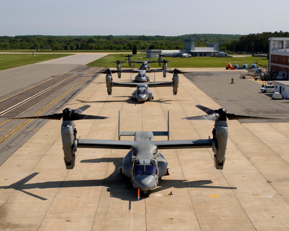 US Navy 030601-N-0000X-001 Four V-22 Osprey aircraft sit along the flight line with rotors turning before recent test flights