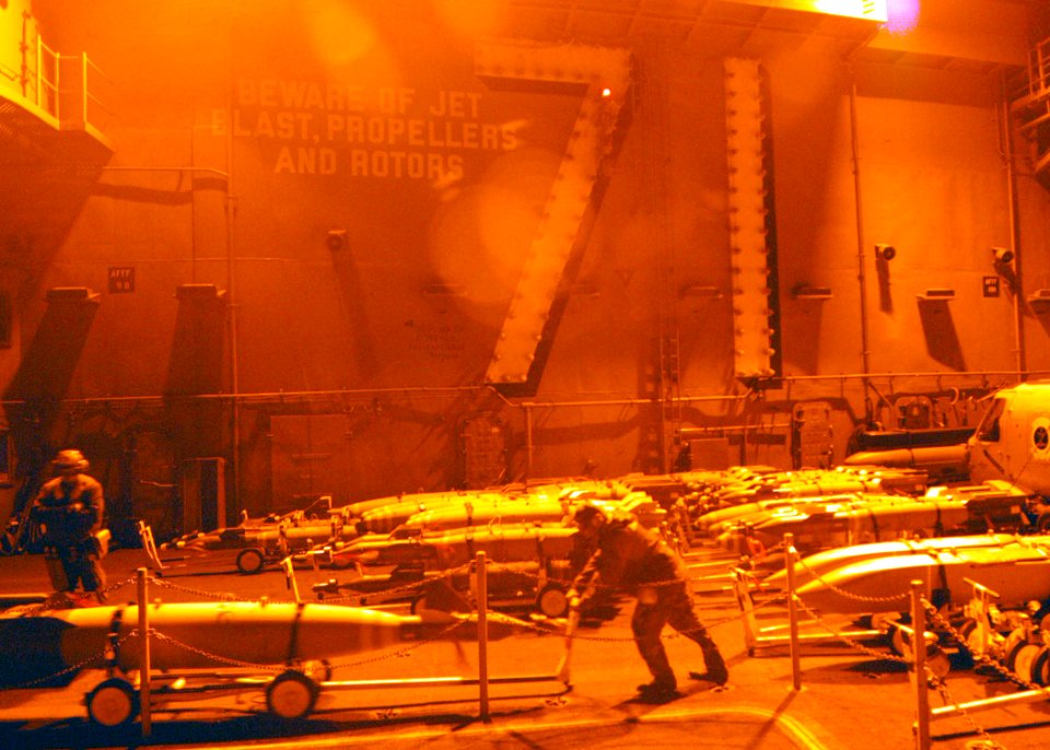US Navy 030403-N-2410G-502 Aviation Ordnancemen move ordnance to Carrier Air Wing Eight (CVW-8) aircraft on the flight deck aboard USS Theodore Roosevelt (CVN 71)