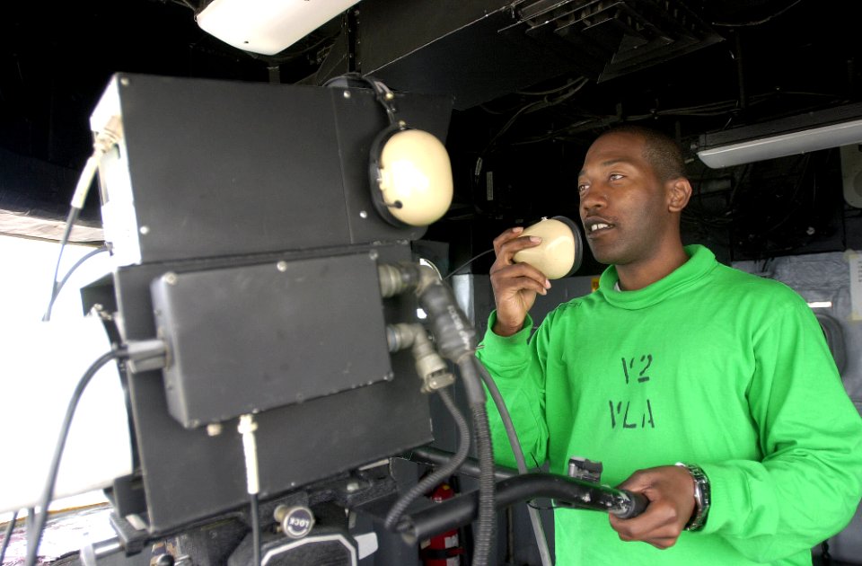 US Navy 030503-N-0413R-005 Airman Curry Allen from Houston, Texas, operates a flight deck camera in the Island Camera Room recording flight deck activities during operations aboard USS Nimitz (CVN 68)
