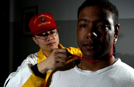 US Navy 030506-N-5862D-001 Electrician's Mate 2nd Class Anthony Phan measures Seaman Recruit Ismail Dale for body fat percentage before the beginning of a Physical Readiness Test (PRT) aboard RTC
