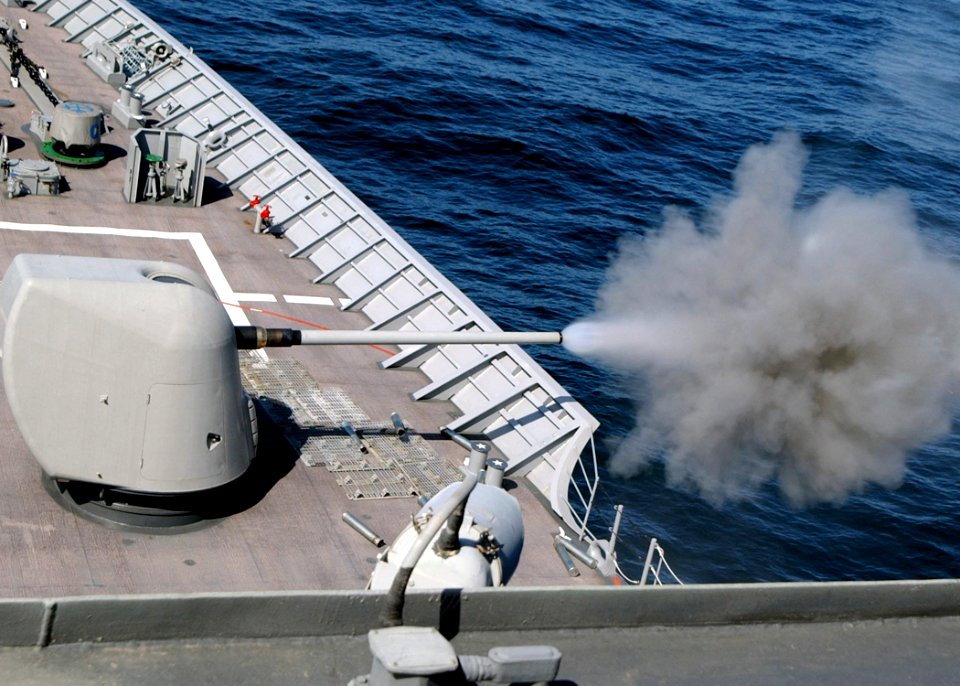 US Navy 030609-N-4374S-007 A cloud of propellant-gas discharge is expelled from the 5-inch gun aboard the aegis cruiser USS Vella Gulf (CG 72)