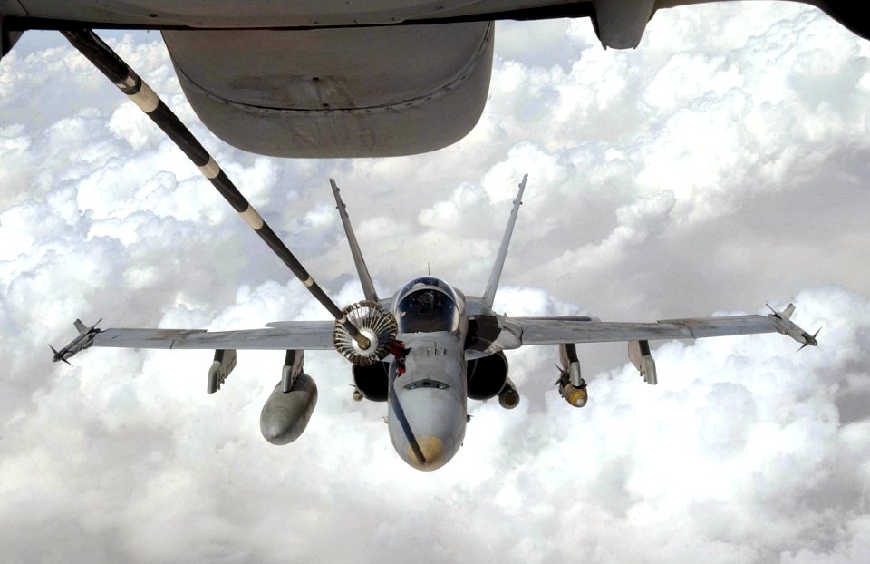 US Navy 030409-F-1631A-001 A U.S. Navy F-A-18 Hornet strike fighter flying missions in Operation Iraqi Freedom receives fuel from a KC-10 Extender