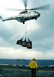 US Navy 030607-N-2819P-022 A SA-332 Super Puma helicopter from Military Sealift Command combat stores ship USNS Spica (T-AFS 9) delivers pallets of supplies to USS Kearsarge (LHD 3)