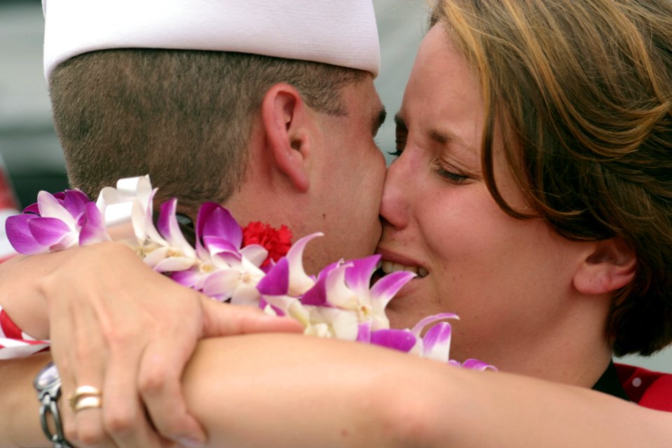 US Navy 030427-N-3228G-003 A Sailor reunites with a family member on the pier