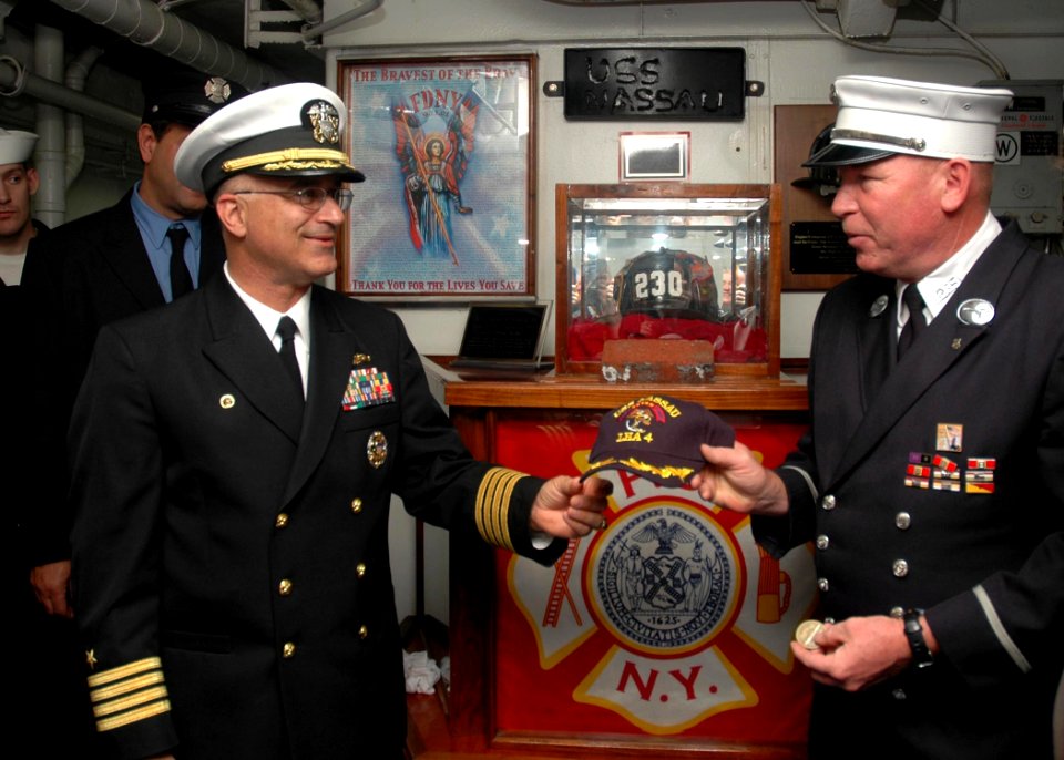 US Navy 081013-N-1003P-026 Capt. James Boorujy presents Lt. John Cullen a Nassau commanding officer ball cap