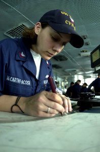 US Navy 030517-N-1577S-002 Quartermaster 2nd Class Graham Acosta plots the position of the ship while standing Quartermaster of the Watch (QMOW) aboard USS Nimitz (CVN 68) photo