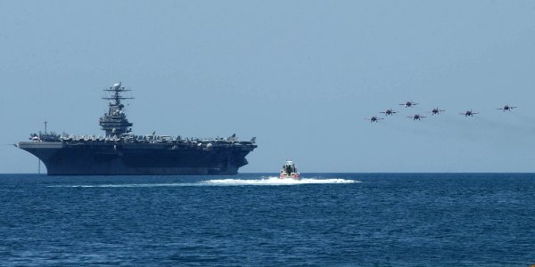 US Navy 030516-N-1328C-505 An Acrobatic Group of Spain aircraft perform aerial maneuvers over USS Theodore Roosevelt (CVN 71), anchored off the coast of Cartagena, Spain