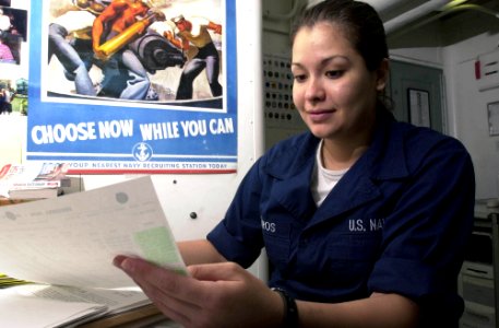 US Navy 030411-N-1577S-001 Personnelman Robin Cisneros of Corpus Christi, Texas reviews the enrollment sheet for English 1301 in the Education Services Office aboard USS Nimitz (CVN 68) photo