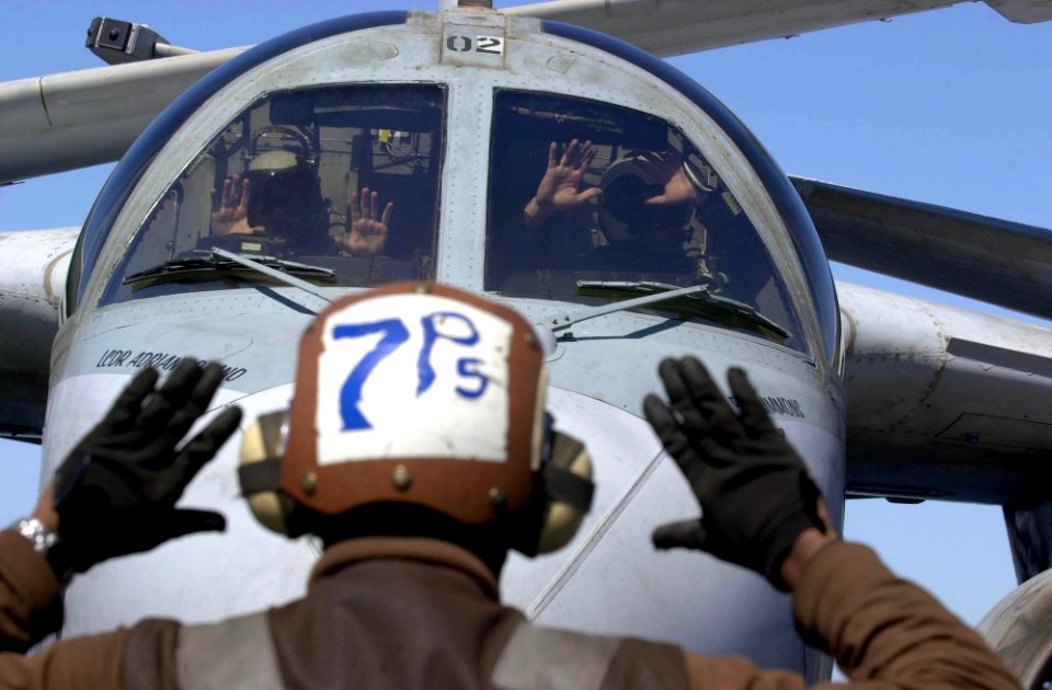 US Navy 030430-N-2385R-001 Airman Tyron Fedderman signals to the flight crew of an S-3B Viking
