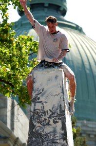 US Navy 030519-N-5319A-007 Daniel Shea, a United States Naval Academy freshmen from Lakehurst N.Y., signals from atop the Herndon Monument, a 21-foot obelisk covered with more than 200 lbs. of lard